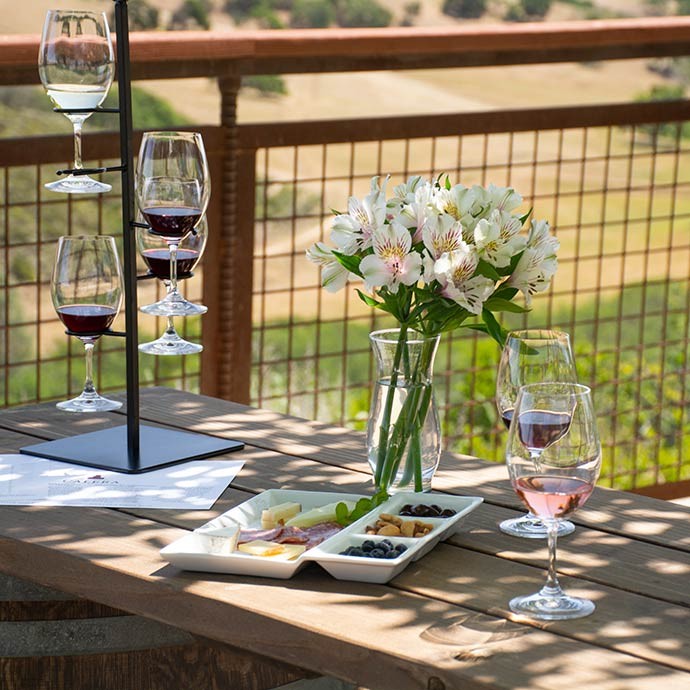Calera wine glasses and cheese plate outside