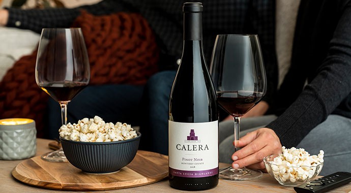 Calera wine bottle on coffee table with popcorn