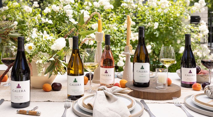 Calera wines on a table with wine and fruit