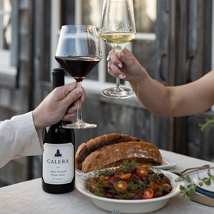 Calera new releases on a table with bread and cherries