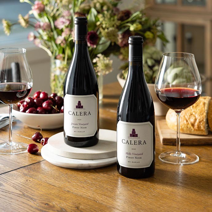 Calera new releases on a table with bread and cherries