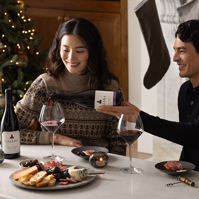 Two women talking in the kitchen while drinking Calera wine.
