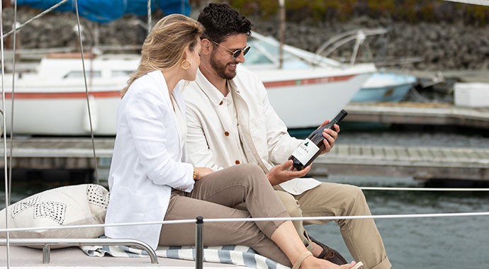Calera Central Coast Chardonnay being held by a man on a boat