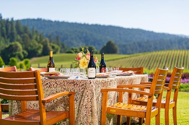 Goldeneye table outdoors with vineyard view